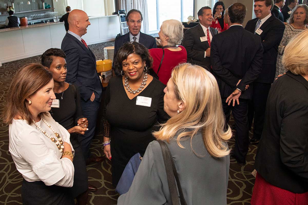 Board of Visitors members mingling before the spring meeting.