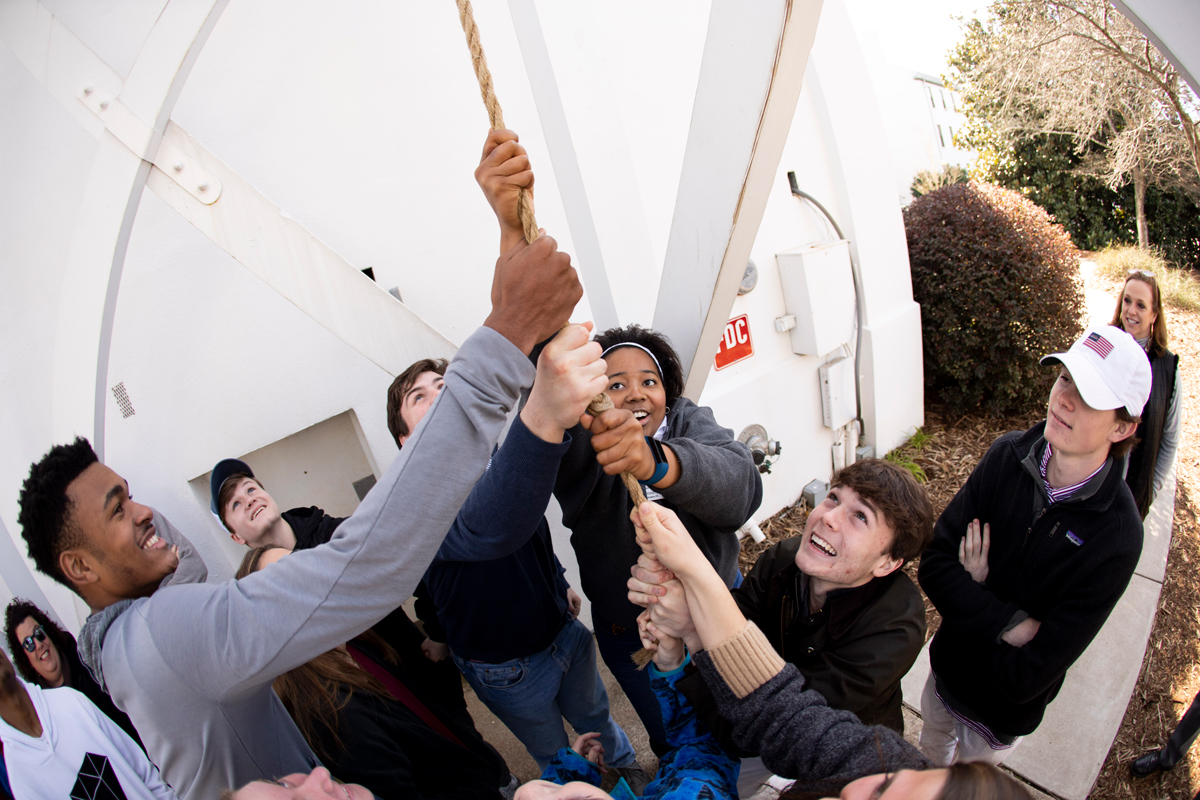 Prospective students ring the Chapel Bell while touring campus